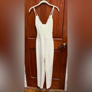 White/Cream Express Jumpsuit with a crisscross back and a lace style front